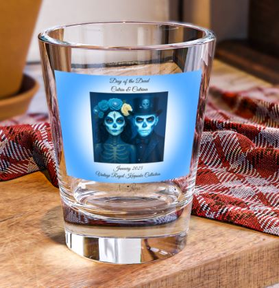 right side view of 1.5oz shot glass showing detailed day of the dead couple portrait in blue tones