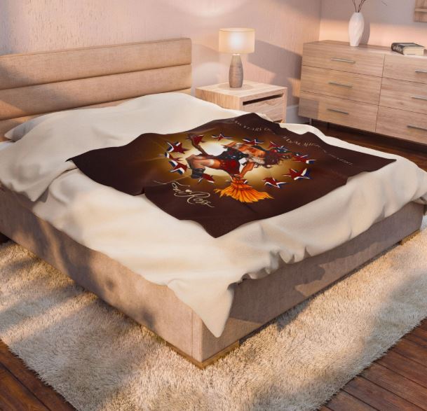 Americana velveteen blanket styled on bed with warm glowing background and vintage witch artwork