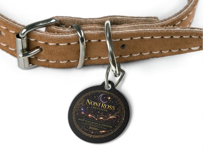 Round pet collar tag with NRC celestial design attached to dog collar in outdoor setting
