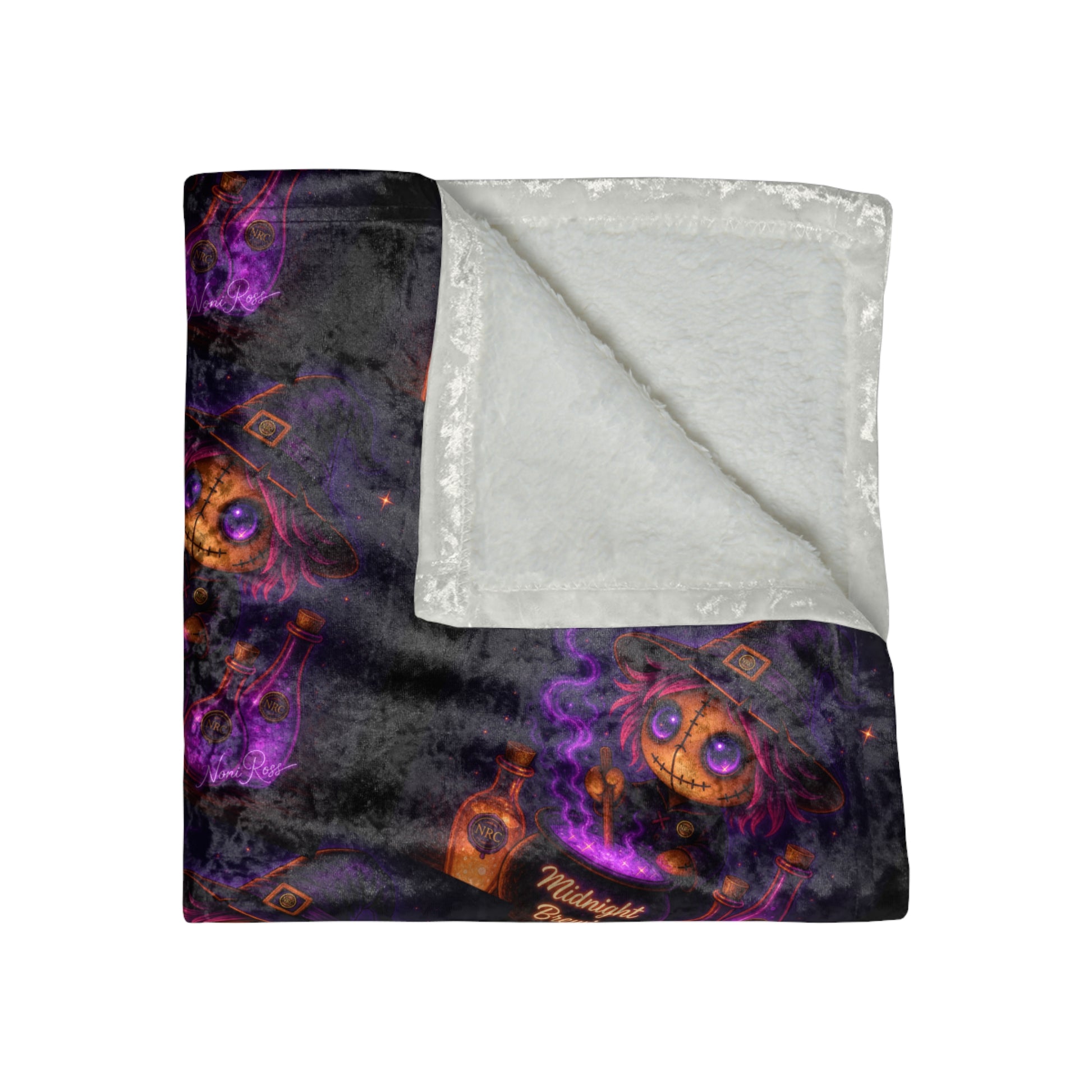 Folded velvet blanket showing soft plush interior and vibrant Midnight Brewin witch pattern detail